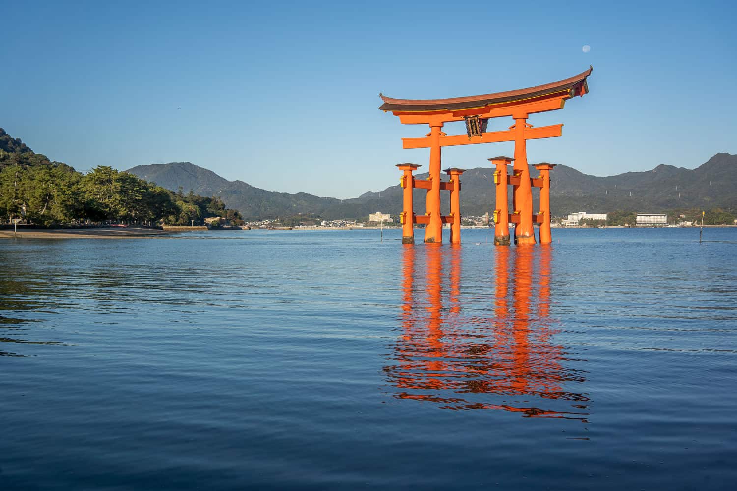 Giant torii gate at high tide on Miyajima Island, Japan with reflection in water