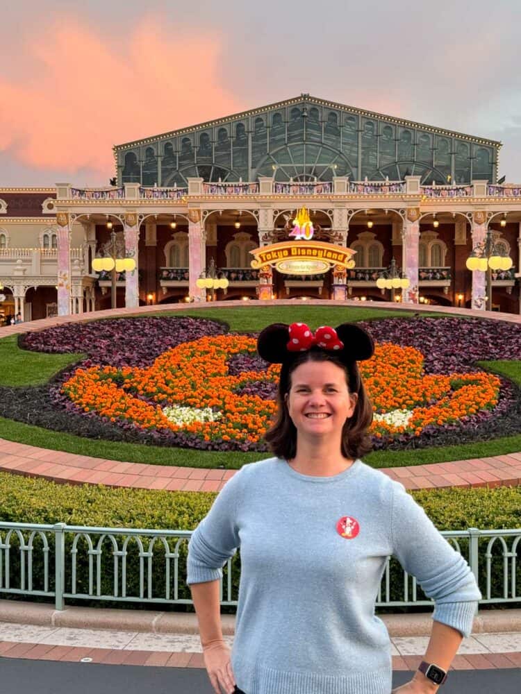 Erin at the Tokyo Disneyland entrance at sunset