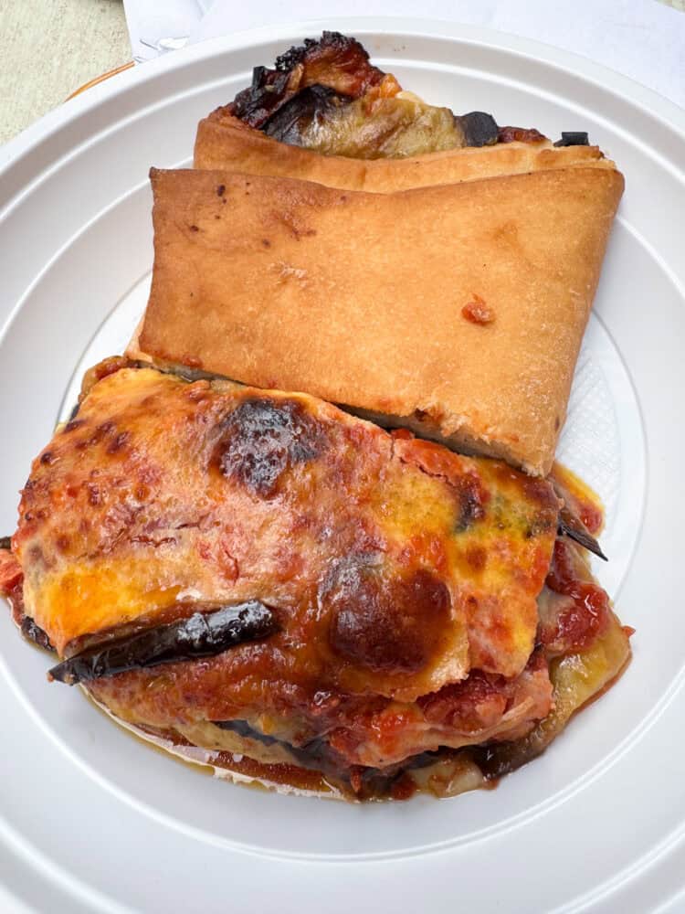 Sicilian impanata with melanzana and melanzana parmigiana at U Siciliano Ortigia restaurant in Siracusa, Sicily.