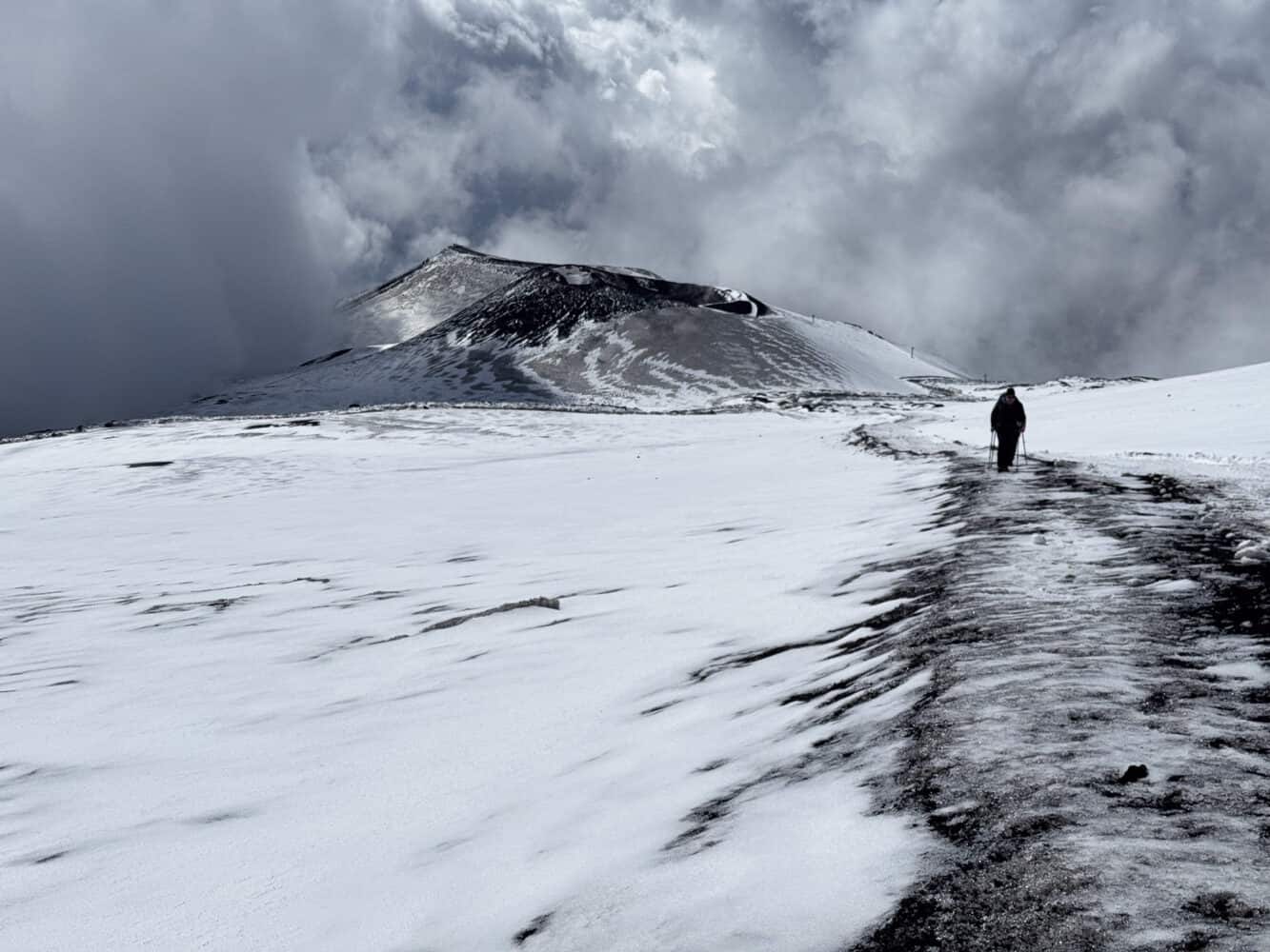 Hiking near a crater on Mt Etna in the snow.
