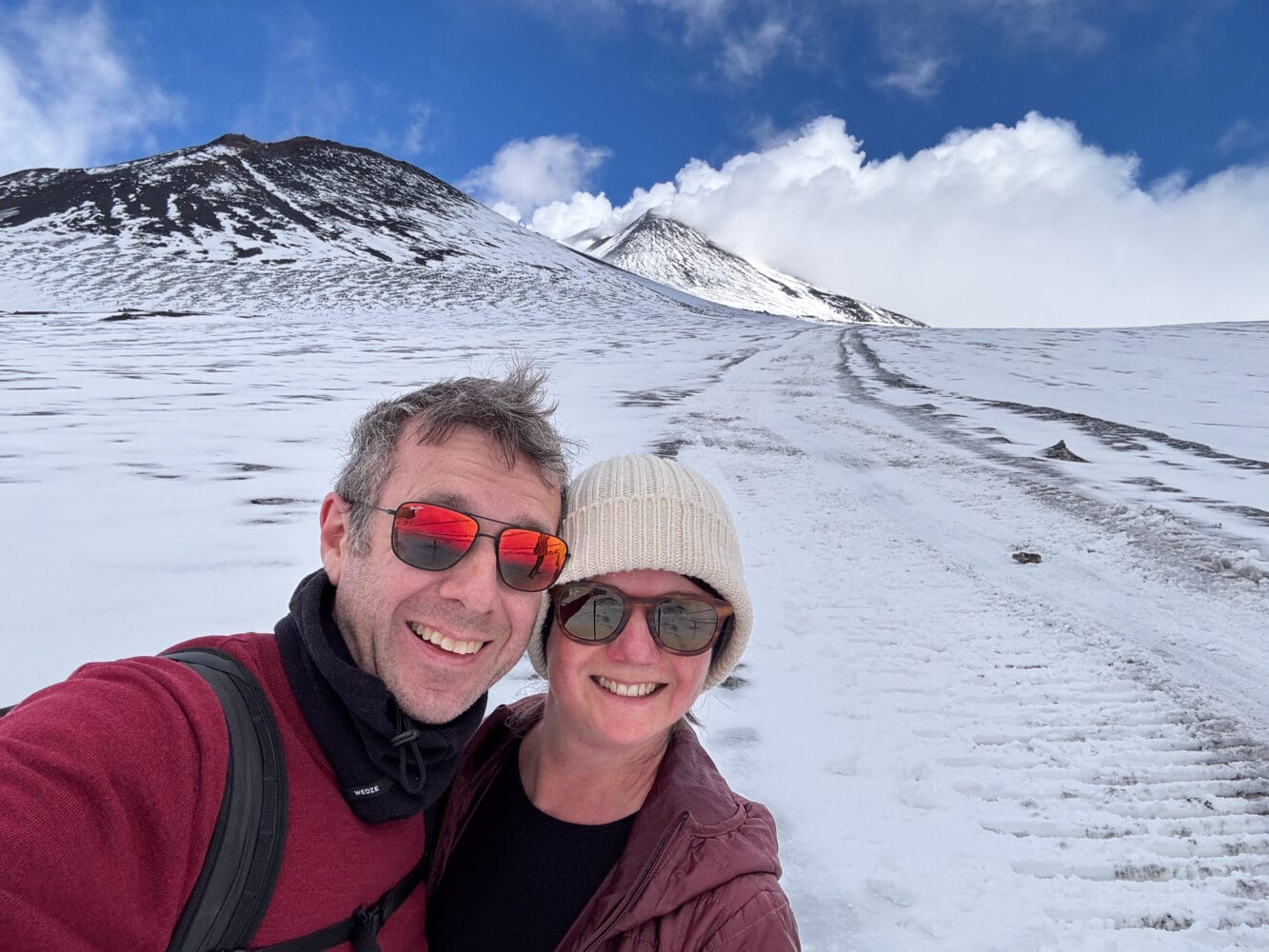 Simon and Erin hiking up Mt Etna in the snow.