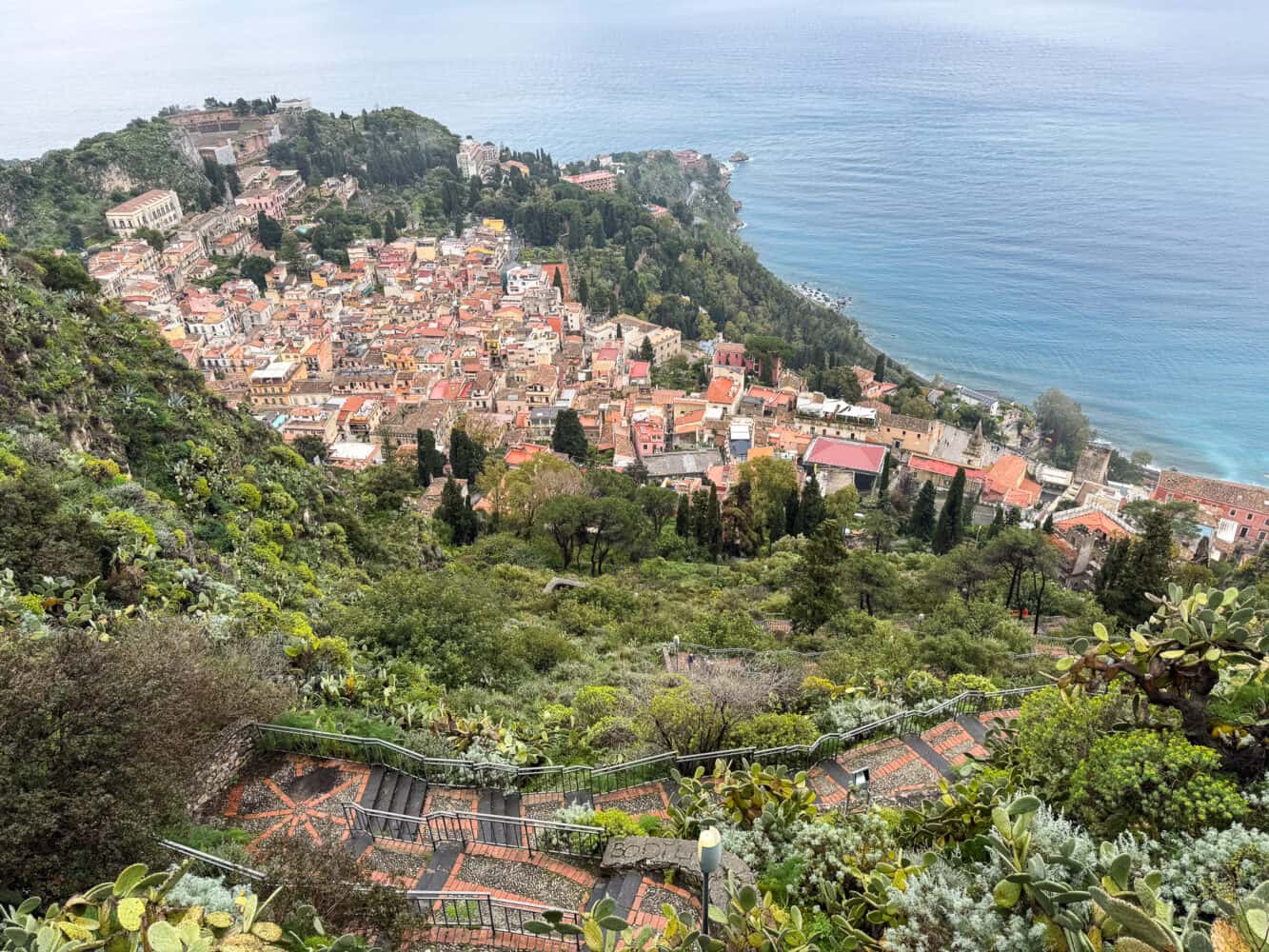 The staircase that leads up to Chiesa Madonna della Rocca and views of Taormina.