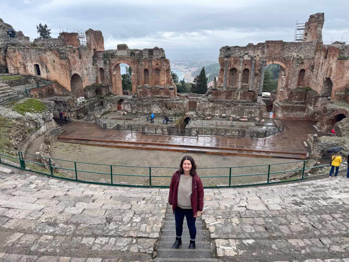 Erin at the Greek Theatre in Taormina, Sicily on a rainy day.