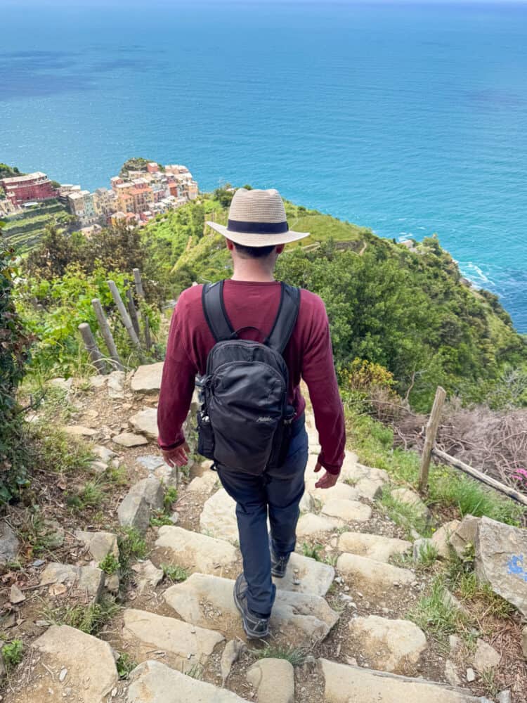 Walking down steps on the Corniglia to Manarola hike via Volastra in Cinque Terre, Liguria, Italy