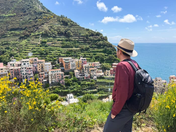 Simon looking down at Manarola from the Corniglia to Manarola hike (via Volastra) in Cinque Terre, Italy.