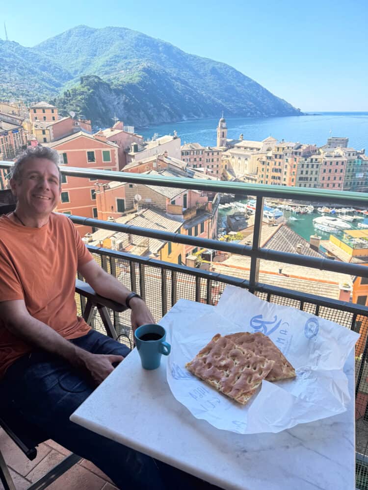 Simon eating focaccia on the balcony of our apartment in Camogli, Italy.