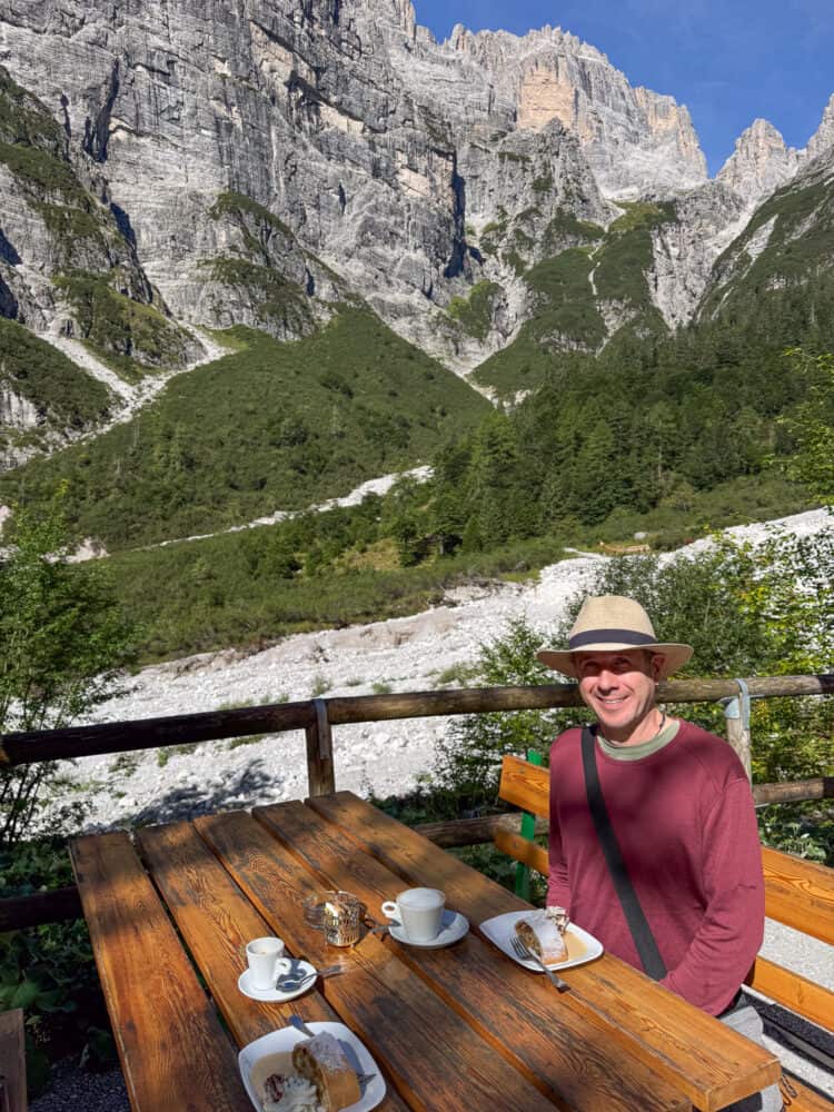 Simon eating apple strudel at Rifugio Croz dell'Altissimo in the Brenta Dolomites, Italy.