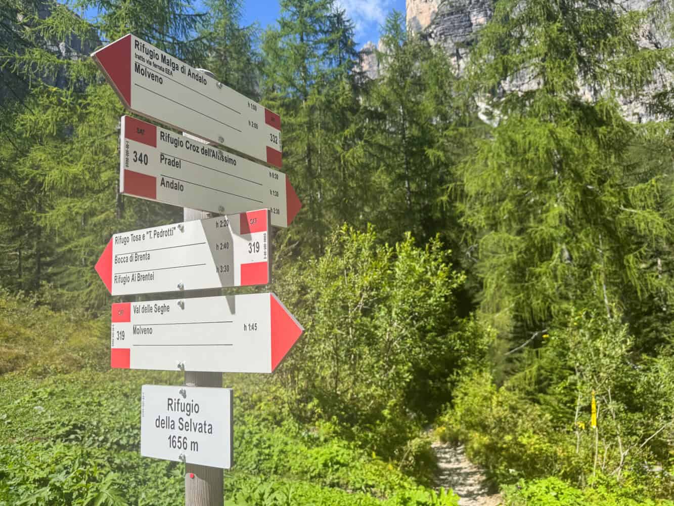 Signposts on the trail by Rifugio Selvata in Brenta Dolomites.