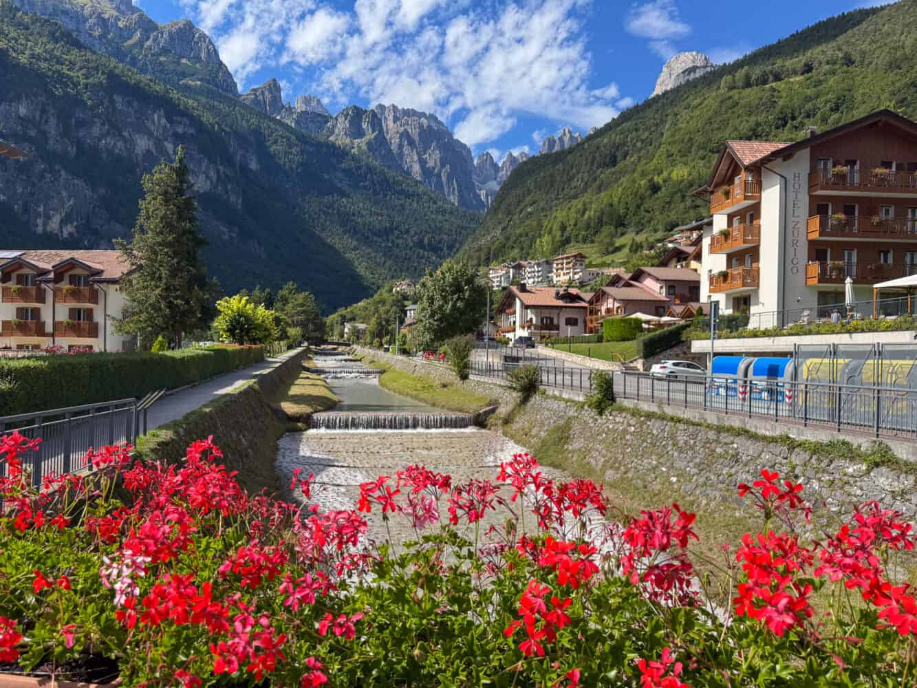 Molveno village with the river and flower boxes.