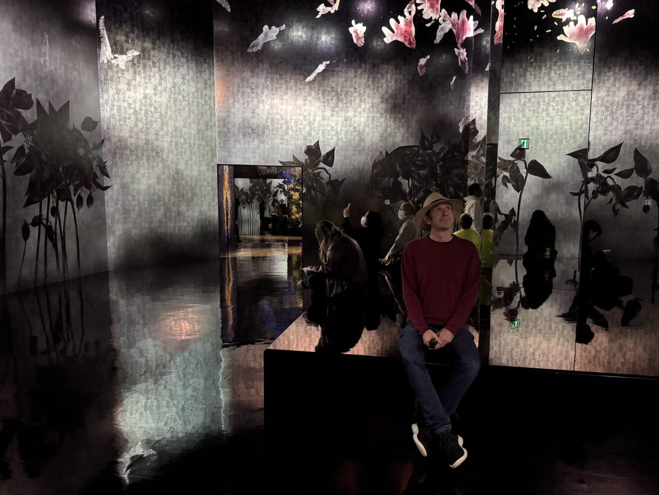 Seating area in Silent Radiance Within flower room at TeamLab Biovortex Kyoto.