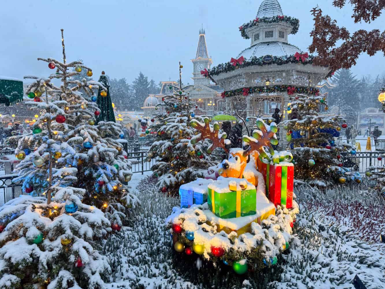 Pluto by the smaller Christmas Trees at Disneyland Paris.