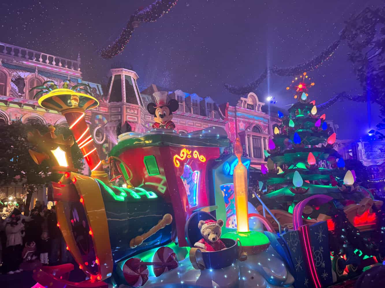 Mickey and Duffy the Bear in the evening Mickey's Dazzling Christmas Parade at Disneyland Paris.