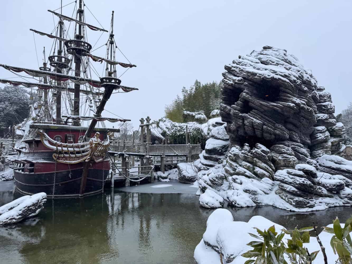 Pirate Galleon and Skull Rock covered in snow at Disneyland Paris.