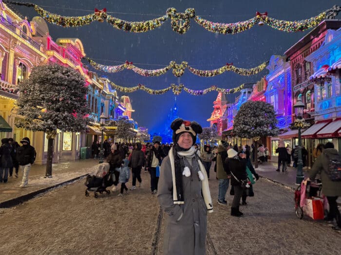 Main Street at Disneyland Paris at Christmas lit up at night.