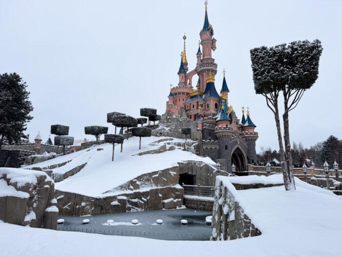 Sleeping Beauty Castle covered in snow at Disneyland Paris.