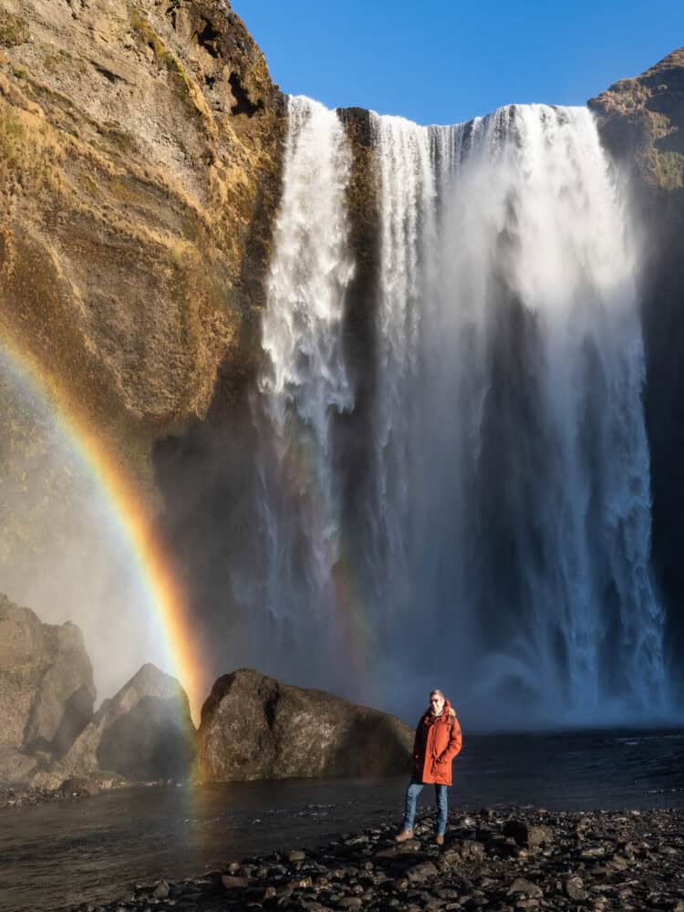 A rainbow and golden winter light at Skogafoss waterfall in South Iceland.