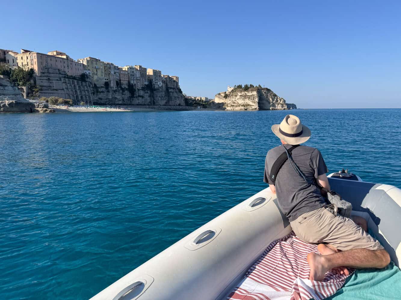 Simon in a boat with Tropea, Calabria beyond.